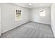 Bright bedroom with new gray carpet and large windows at 5012 Maplecrest Dr, Gastonia, NC 28056