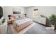 Stylish bedroom with a comfortable bed, modern decor, and a large window at 5012 Maplecrest Dr, Gastonia, NC 28056