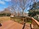 Wooden deck with railing offering an outdoor living space surrounded by a lush, tree-filled landscape at 5012 Maplecrest Dr, Gastonia, NC 28056