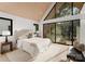 Bedroom boasts large windows with backyard view, wooden ceiling and a modern minimalist style at 5500 Carmel Rd # 101, Charlotte, NC 28226