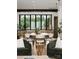 Open-concept dining area featuring modern lighting, large windows, and a view into the kitchen area at 5500 Carmel Rd # 101, Charlotte, NC 28226