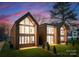 Stunning new construction featuring striking modern design, spacious windows, and lush lawn at 5500 Carmel Rd # 101, Charlotte, NC 28226
