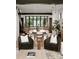 Open-concept living area with modern chairs, hardwood floors, stylish furnishings, and a sleek staircase at 5500 Carmel Rd # 101, Charlotte, NC 28226