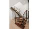 Modern staircase with wood treads, glass railings, and steel supports, seamlessly blends form and function in a contemporary design at 5500 Carmel Rd # 101, Charlotte, NC 28226