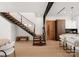 Modern staircase featuring wood treads, glass railings, and sleek design, seamlessly connecting living spaces with contemporary elegance at 5500 Carmel Rd # 101, Charlotte, NC 28226