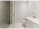 Stylish bathroom with tiled shower, glass door, and modern gold fixtures, offers a clean and modern aesthetic at 5500 Carmel Rd # 103, Charlotte, NC 28226