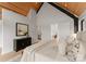 Bright bedroom featuring wood ceilings, stylish furnishings, and a glimpse into the bathroom at 5500 Carmel Rd # 103, Charlotte, NC 28226