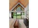 Bright bedroom featuring wood ceilings, large windows offering outdoor views, and stylish furnishings at 5500 Carmel Rd # 103, Charlotte, NC 28226