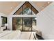 Modern bedroom featuring wood ceilings, large windows offering outdoor views, and simple furnishings at 5500 Carmel Rd # 103, Charlotte, NC 28226