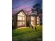 Stunning modern homes with striking architectural design and manicured lawns at dusk at 5500 Carmel Rd # 103, Charlotte, NC 28226