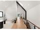 Second floor hallway with a seating area, railing, and skylight at 5500 Carmel Rd # 103, Charlotte, NC 28226