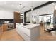 Modern kitchen featuring a large island, stainless steel appliances and an open concept layout to the stairs at 5500 Carmel Rd # 103, Charlotte, NC 28226