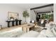 Open living room with hardwood floors, modern decor and an open concept layout to the kitchen and stairs at 5500 Carmel Rd # 103, Charlotte, NC 28226