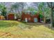 Brick home with a walkout basement, multiple windows, and a lush backyard at 5536 Seacroft Rd, Charlotte, NC 28210