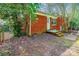 Brick home exterior with a small patio and fenced backyard, offering privacy and outdoor space at 5536 Seacroft Rd, Charlotte, NC 28210