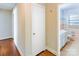 Hallway view into bathroom with tile walls, and natural light at 5536 Seacroft Rd, Charlotte, NC 28210