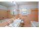 Bathroom featuring a sink, toilet, and bathtub with a window for natural light at 5536 Seacroft Rd, Charlotte, NC 28210