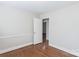Bedroom featuring hardwood floors and a door into another room at 5536 Seacroft Rd, Charlotte, NC 28210