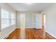 Spacious bedroom with hardwood floors, a closet, and an adjoining bathroom at 5536 Seacroft Rd, Charlotte, NC 28210