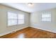 Bright bedroom with two windows and hardwood floors at 5536 Seacroft Rd, Charlotte, NC 28210