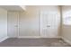 Bedroom featuring plush carpet, window and a closet with bi-fold doors at 5536 Seacroft Rd, Charlotte, NC 28210