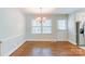 Cozy dining room with hardwood floors, classic chandelier, and bright window, creating an inviting space for meals at 5536 Seacroft Rd, Charlotte, NC 28210
