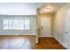 Inviting foyer with hardwood floors and a window adding light, providing a welcoming entry to the home at 5536 Seacroft Rd, Charlotte, NC 28210