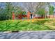 Charming two-story brick home with a well-manicured lawn, shaded by mature trees, creating inviting curb appeal at 5536 Seacroft Rd, Charlotte, NC 28210