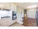 Bright kitchen features stainless steel appliances and a breakfast bar that opens to dining room at 5536 Seacroft Rd, Charlotte, NC 28210
