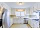 Bright kitchen features white cabinetry, stainless steel appliances, and great natural light at 5536 Seacroft Rd, Charlotte, NC 28210