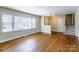 Open living area with hardwood floors, large windows, and a decorative partition wall, creating a warm and inviting space at 5536 Seacroft Rd, Charlotte, NC 28210