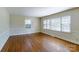 Bright living room features hardwood floors, large windows allowing ample natural light, and neutral wall color at 5536 Seacroft Rd, Charlotte, NC 28210