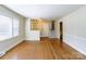 Spacious living area featuring hardwood floors, large windows, and direct access to the staircase, creating an airy atmosphere at 5536 Seacroft Rd, Charlotte, NC 28210