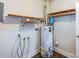 Utility room featuring a water heater, shelving and connections for a washing machine and dryer at 5536 Seacroft Rd, Charlotte, NC 28210