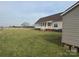 Expansive backyard with a well-kept lawn and a covered porch, offering a serene outdoor space at 6795 Jones Rd, Salisbury, NC 28147