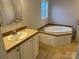 Bathroom with dual vanities, countertops, sink, and garden tub at 6795 Jones Rd, Salisbury, NC 28147
