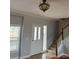 Bright foyer featuring tiled floors, staircase, chandelier, and natural light from the sidelight at 6795 Jones Rd, Salisbury, NC 28147