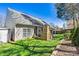 Picturesque backyard featuring a stone fireplace, lush lawn, and privacy landscaping, ideal for relaxing or hosting gatherings at 7331 Sedgebrook W Dr, Stanley, NC 28164