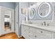 Modern bathroom with double vanity, decorative mirrors, and walk-in shower at 7331 Sedgebrook W Dr, Stanley, NC 28164