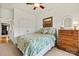 Cozy bedroom featuring floral bedding, wood dresser, and decor at 7331 Sedgebrook W Dr, Stanley, NC 28164