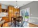 Breakfast nook provides backyard access via sliding glass door and includes wood cabinets and decorative decor at 7331 Sedgebrook W Dr, Stanley, NC 28164