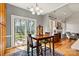 This sunlit breakfast nook features sliding glass door to the patio and flows into the living room with a fireplace at 7331 Sedgebrook W Dr, Stanley, NC 28164