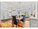 Bright formal dining room with natural light from a large window, wooden floors, and seating for four at 7331 Sedgebrook W Dr, Stanley, NC 28164