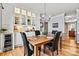 Formal dining area with modern chandelier, wine cooler, and wooden floors for elegant entertaining at 7331 Sedgebrook W Dr, Stanley, NC 28164