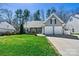 Beautiful home showcasing a green lawn, gray siding, and an attached two-car garage at 7331 Sedgebrook W Dr, Stanley, NC 28164
