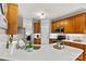 Open-concept kitchen features wooden cabinets, stainless steel appliances, and white countertops for a bright and functional space at 7331 Sedgebrook W Dr, Stanley, NC 28164