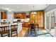 Kitchen boasts natural wood cabinets, recessed lighting, and a sliding door view to the backyard and light-filled breakfast nook at 7331 Sedgebrook W Dr, Stanley, NC 28164