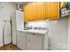 Well-lit laundry room featuring washer, dryer, storage and ironing board at 7331 Sedgebrook W Dr, Stanley, NC 28164