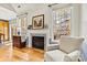 Cozy living room showcasing a fireplace, hardwood flooring, and two large windows at 7331 Sedgebrook W Dr, Stanley, NC 28164