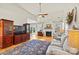 Bright living room with a fireplace, hardwood floors, and large windows offering natural light at 7331 Sedgebrook W Dr, Stanley, NC 28164